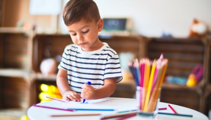 Beautiful-toddler-boy-drawing-cute-draw-using-colored-pencils-at-kindergarten-1185932018_1257x838